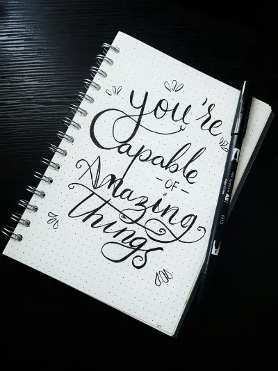 A notebook page that states: "you're capable of amazing things"