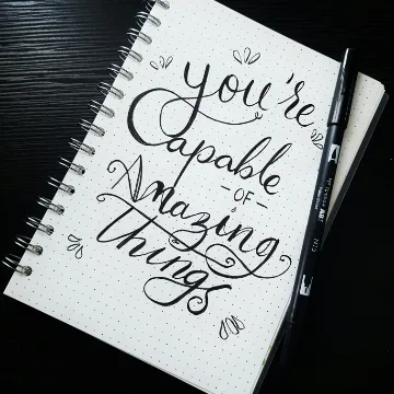 Amazing Things v1 Notebook with cursive message: "You're capable of amazing things"
