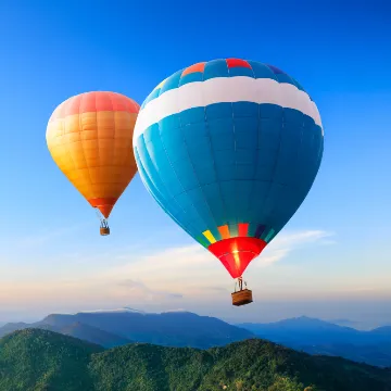 Hot Air Ballons v1 Two hot air balloons against a blue sky with hills below